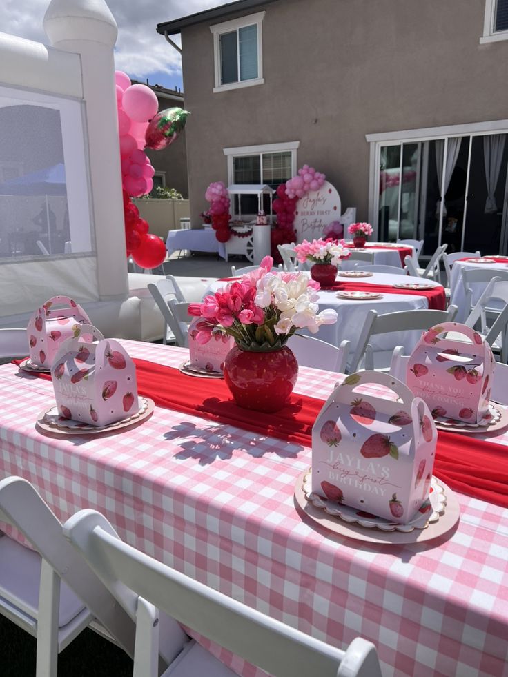 a table set up with pink and white decorations