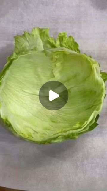 lettuce being cut into pieces with a knife on the table next to it