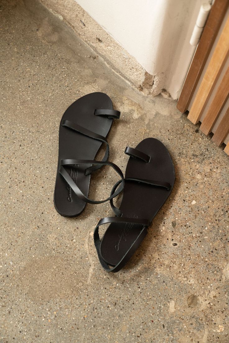 Handmade in Greece out of genuine Greek leather, the Rhodes Sandals are meant for everyday use! The leather sole is durable, thick and textured on the bottom to form a perfectly unique fit. The beautiful natural leather will darken over time as you wear and give them love! FIT Stiff at first, softens up with time If in between sizes, size up or measure your foot to compare with the measurements below Fits many widths Individually Handmade -- each one will not be the exact same. Recommended To Av Leather Toe Ring Sandals With Rubber Sole For Beach, Leather Lined Open Toe Flip Flops For Vacation, Beach Open Toe T-strap Sandals With Leather Lining, Open Toe T-strap Sandals With Leather Lining For Beach, Leather Lined Open Toe T-strap Sandals For Beach, Leather Toe Ring Sandals With Rubber Sole For Vacation, Leather Lined Open Toe Sandals For Beach, Beach Toe Ring Sandals With Round Toe Leather Lining, Vacation Sandals With Leather Lining And Open Toe