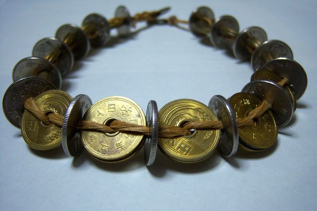 a bracelet made out of coins and rope