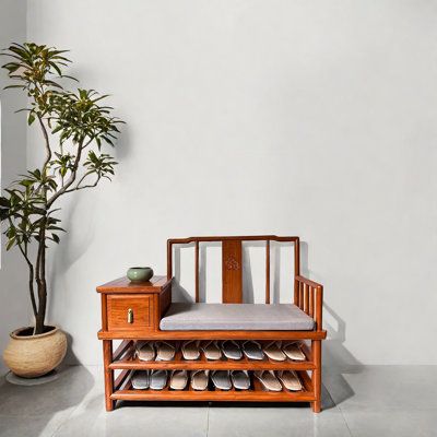 a wooden bench sitting next to a potted plant on top of a white floor