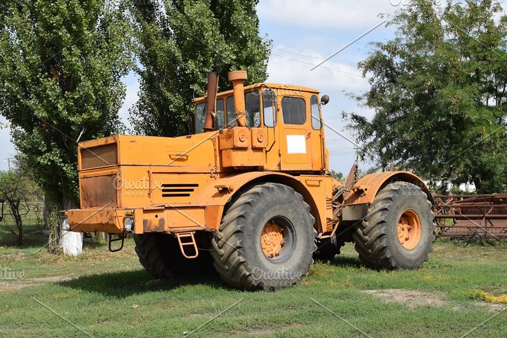 an orange tractor parked in the grass