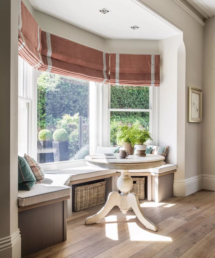 the sun shines through the window in this room with white walls and wooden flooring