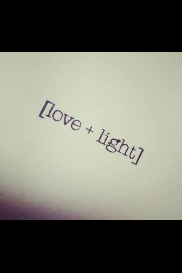 the word love and light written in black ink