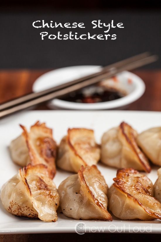 some food is sitting on a plate with chopsticks