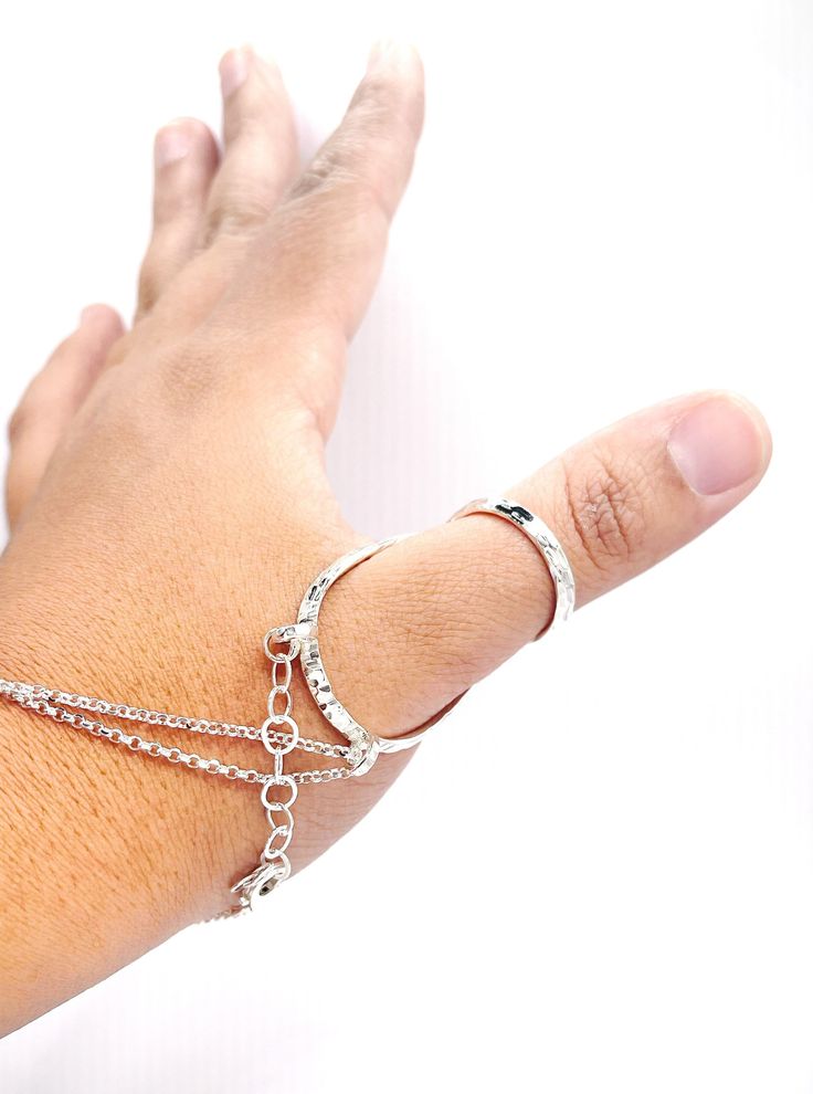 "The Hammered Thumb MCP Sterling Silver Splint Ring helps to block hyperextension of the MCP joint, it comes with a bracelet that gives it support to keep the thumb in its place. -Use on thumbs that hyperextend at the MCP -Use if you have at least 25 degrees of MCP flexion Our goal is to help you feel some comfort while wearing a beautiful piece made with love. We make jewelry with soul, at affordable prices, we want our pieces to help you in any way they can, and of course, that you love the wa Metal Double Band Bracelet Jewelry, Metal Jewelry With Double Band Bracelet Strap, Adjustable Stackable Silver Midi Rings, Adjustable Double Band Jewelry With Adjustable Chain, Adjustable Metal Bracelet With Open Ring Design, Adjustable Silver Ring With Chain, Adjustable Metal Open Ring Bracelets, Adjustable Stackable Open Ring Bracelets, Silver Dainty Chain Ring