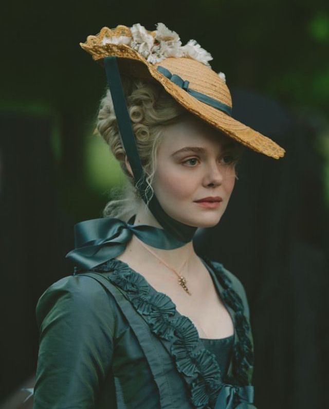 a woman wearing a large hat and green dress