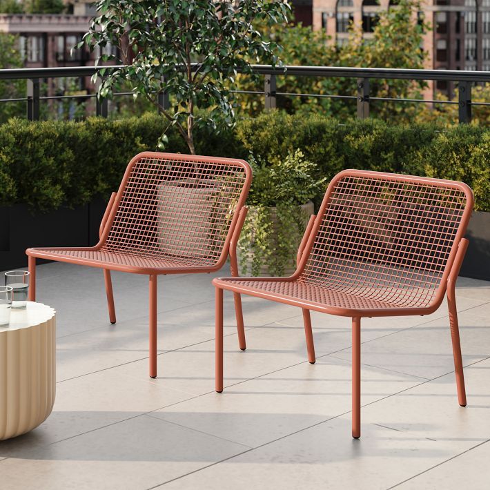 two chairs sitting next to each other on a patio