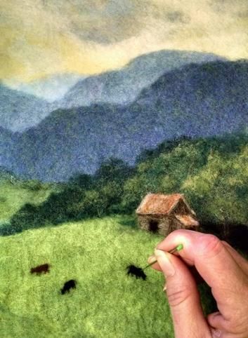 a hand is holding a small house in the middle of a painting