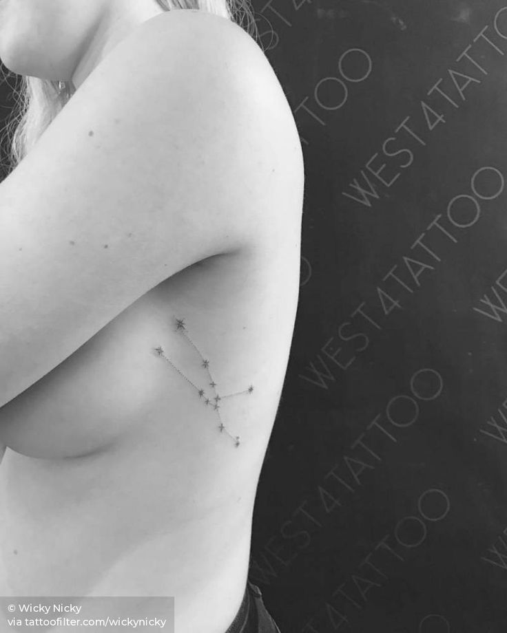 black and white photograph of a woman's breast with stars on it