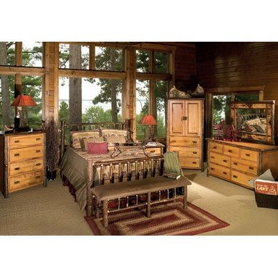 a bedroom with wooden furniture and large windows