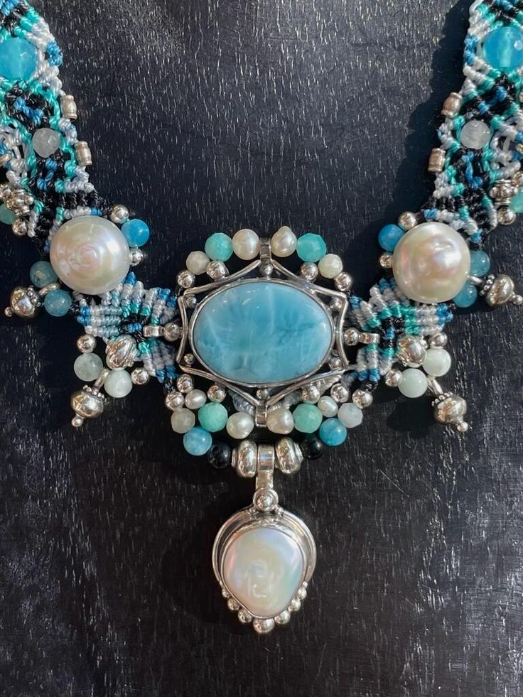 Discover the beauty of our Larimar Necklace featuring natural gems such as Pearl, Moonstone, Onyx, and Amazonite. The rare and stunning Larimar stone makes every piece unique. This necklace radiates elegance and will elevate any outfit with its calming, ocean-inspired colors. Adjustable Length 16" - 30" Handmade Spiritual Aquamarine Necklace, Bohemian Larimar Jewelry With Natural Stones, Bohemian Larimar Natural Stone Jewelry, Bohemian Larimar Necklace For Gift, Elegant Handmade Larimar Jewelry, Larimar Gemstone Pendant Necklaces, Larimar Gemstone Beads Round Jewelry, Larimar Gemstone Pendant Necklace, Round Larimar Gemstone Beads Jewelry