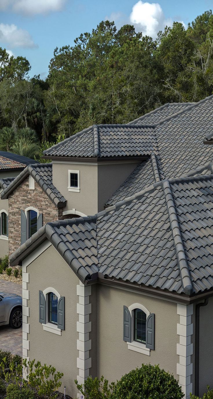 an aerial view of a house with cars parked in the driveway