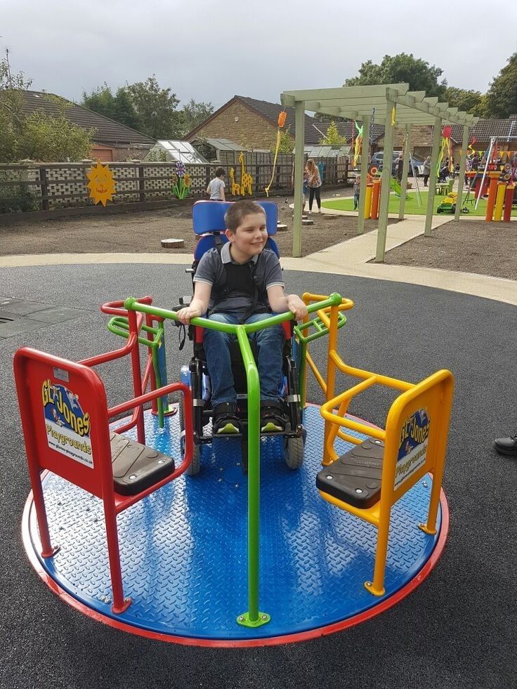 a boy in a wheel chair on a playground