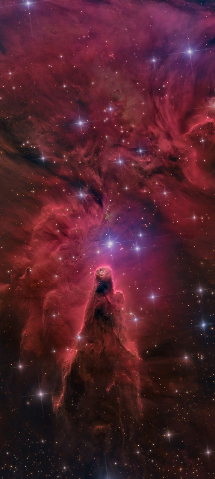 the large magel star in the sky is surrounded by bright stars and red clouds