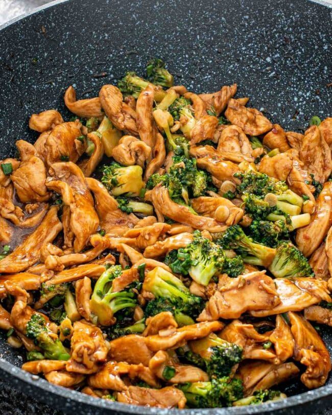 chicken and broccoli stir fry in a wok