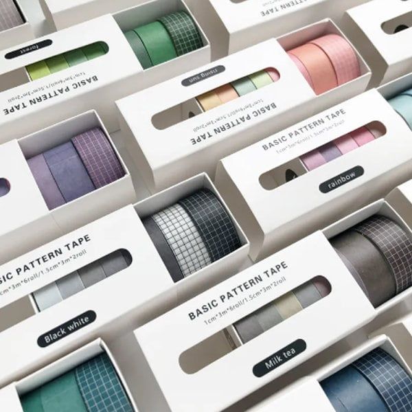 many different colors of ribbon in boxes