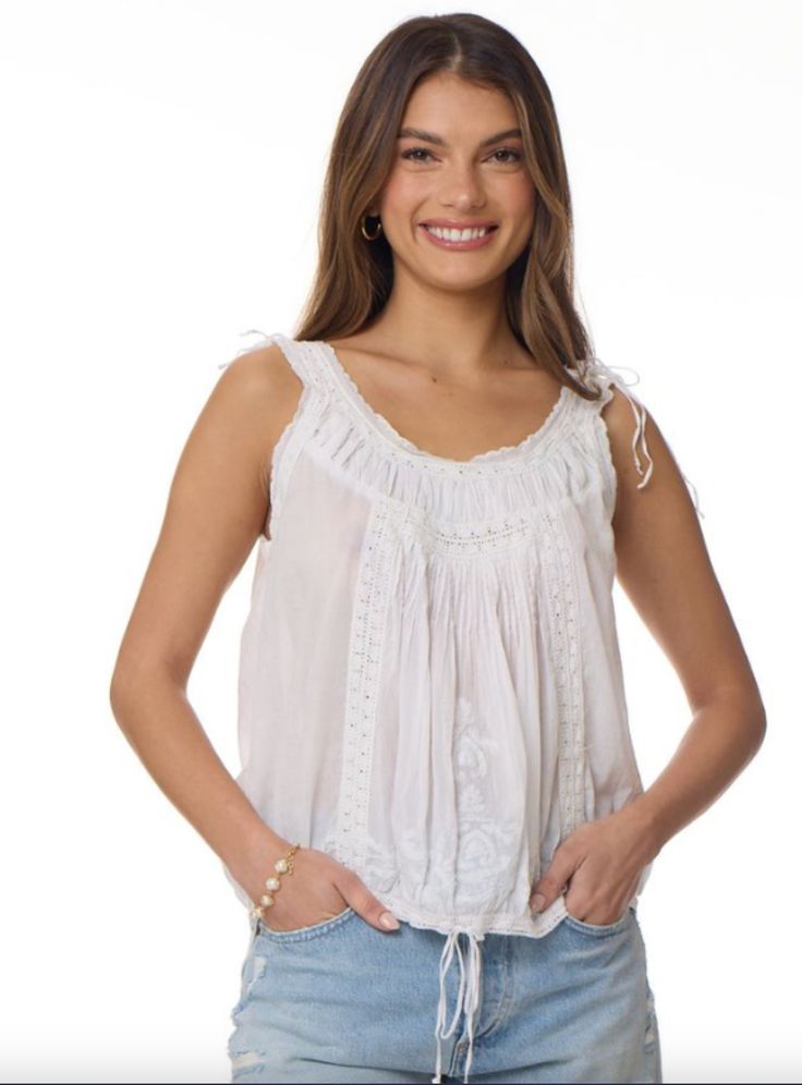 The Cheryl Embroidered Sleeveless Top Natural is a one-of-a-kind piece that will elevate any wardrobe. Made from 100% Indian cotton, this top is not only soft and comfortable, but also environmentally friendly. The natural color adds a touch of simplicity and elegance, making it perfect for any occasion. The intricate embroidery on the top adds a unique and bohemian touch, making it stand out from other tops. The sleeveless design is perfect for warmer weather and can be easily layered for coole Feminine Cotton Embroidered Top For Daywear, Spring Cotton Camisole With Floral Embroidery, Embroidered Cotton Sleeveless Tank Top, Spring Floral Embroidered Cotton Camisole, Embroidered Cotton Camisole Top, Spring Floral Embroidery Cotton Camisole, Floral Embroidered Cotton Tank Top, Cotton Sleeveless Camisole With Floral Embroidery, Cotton Tank Top With Floral Embroidery