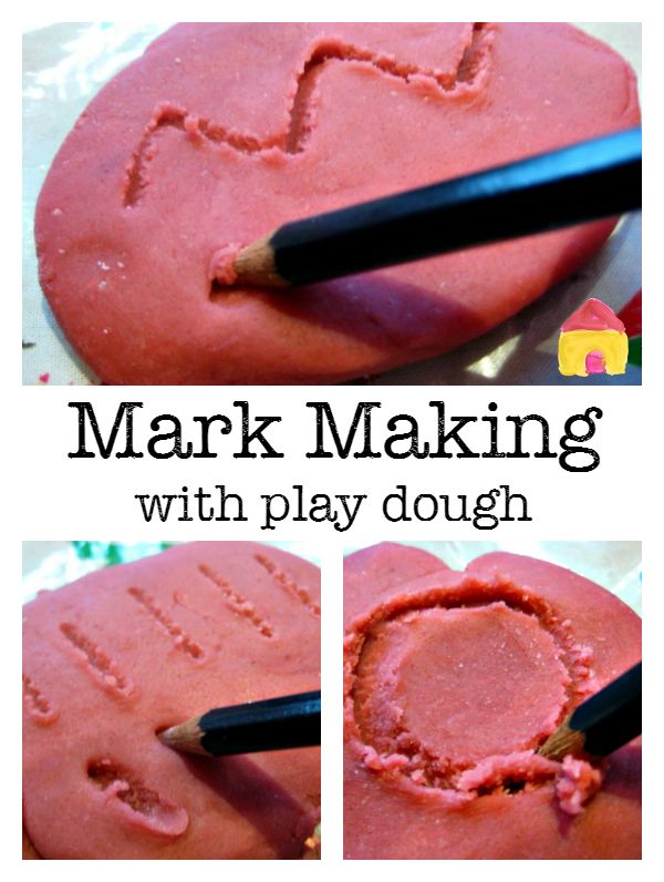 a close up of a heart shaped cake with writing on it and a pencil in the middle