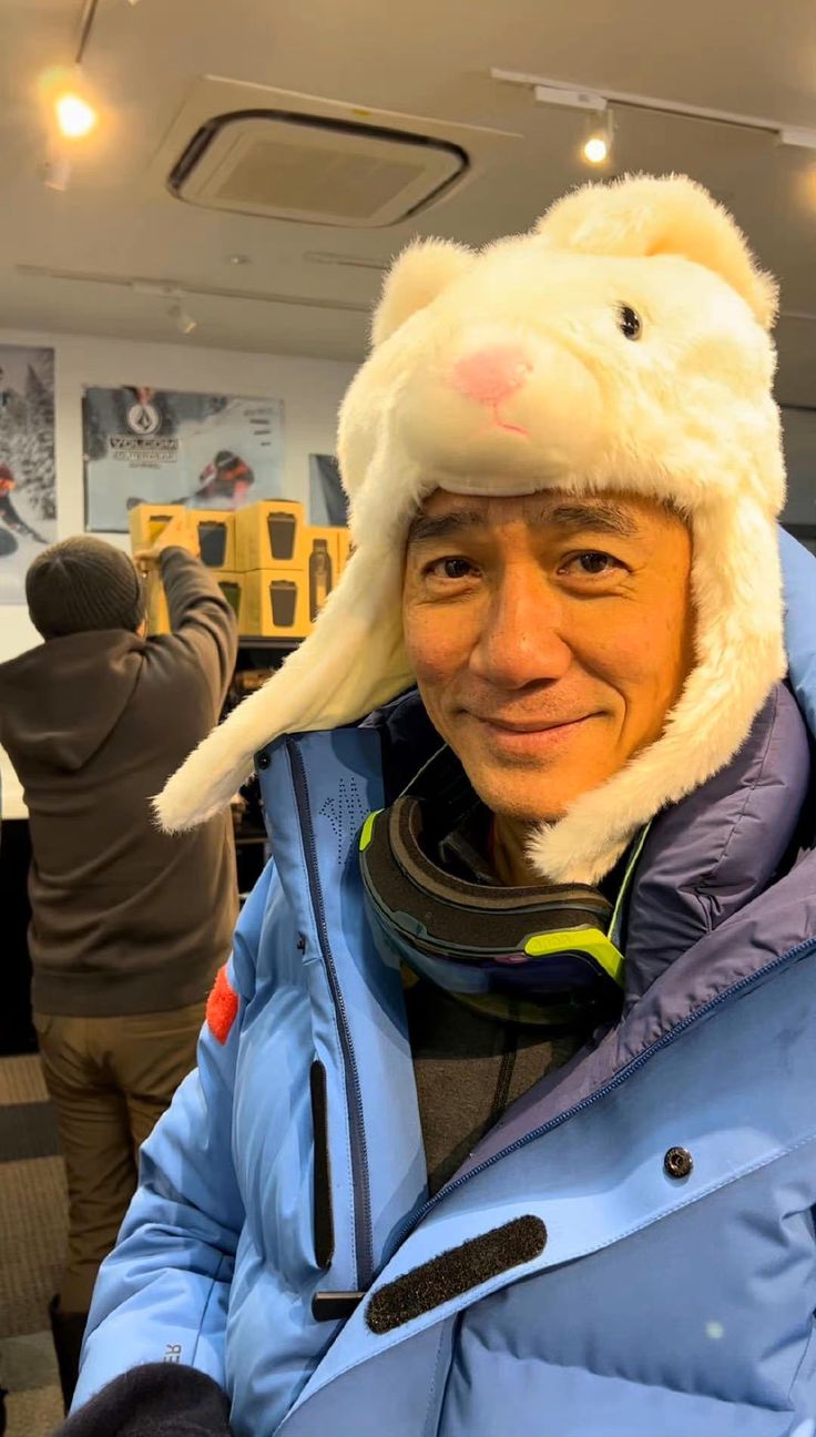 a man wearing a bunny hat and blue jacket