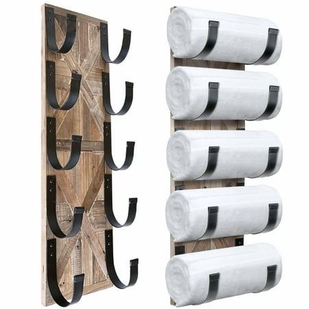 two wooden racks with three rolls of toilet paper hanging on the wall next to each other