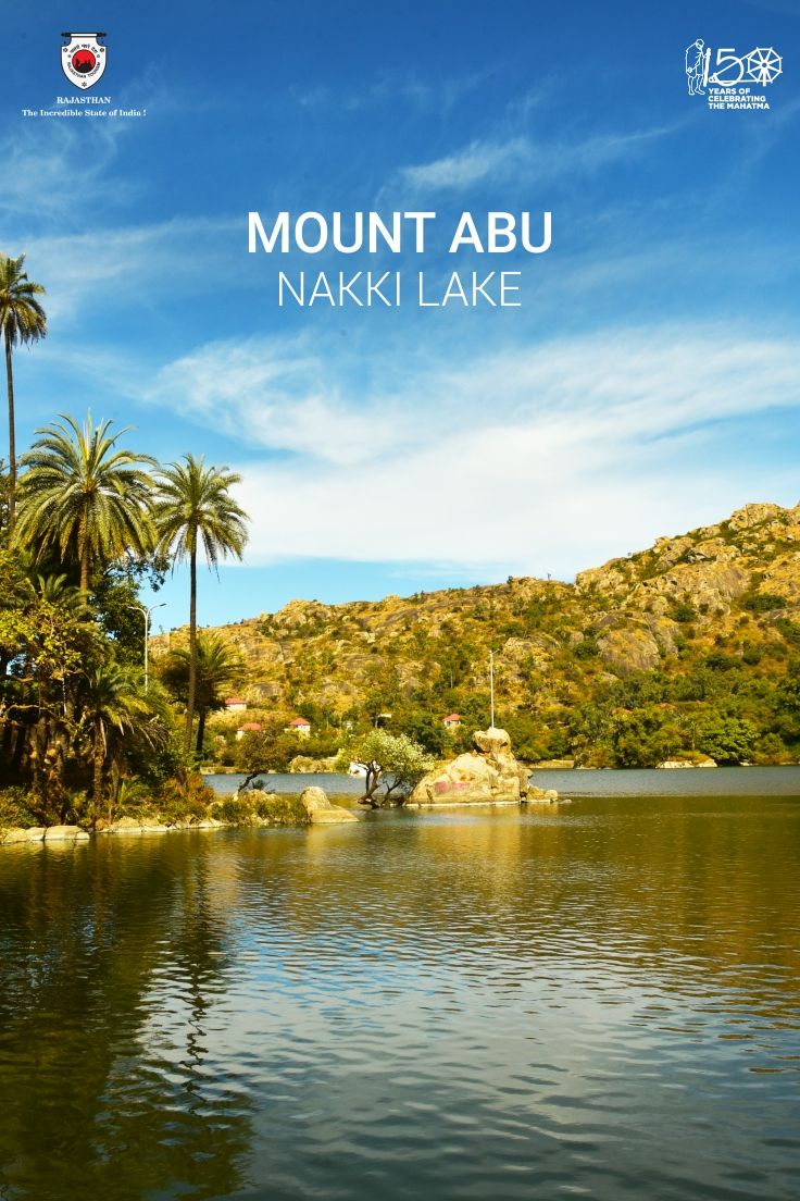 a lake surrounded by palm trees with the words mount abu naki lake on it