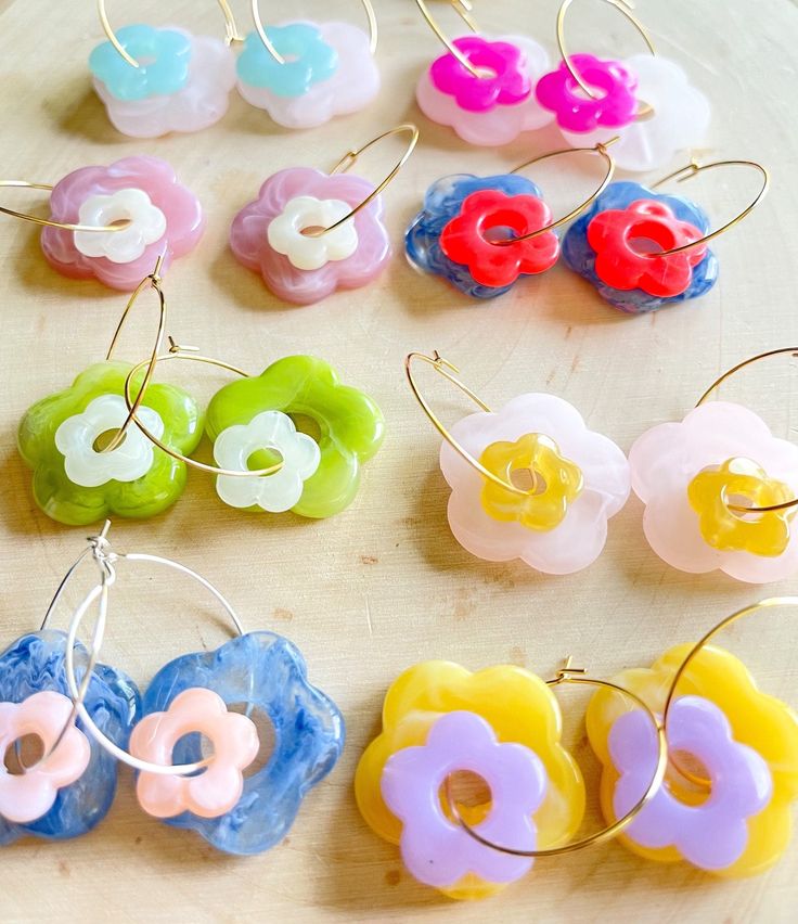 These daisy hoop earrings are the best for any occasion! You can dress them up or down! They come in a variety of fun colors! They are such a fun pop of color! Please put in notes at checkout which colors you would like :) Summer Flower Charm Hoop Earrings, Daisy Shaped Earrings For Summer, Daisy-shaped Earrings For Summer, Trendy Hoop Earrings With Flower Charm For Spring, Handmade Small Hoop Earrings For Spring, Trendy Handmade Flower Earrings, Daisy Flower Earrings For Spring, Spring Daisy Flower Earrings, Cute Adjustable Flower Earrings For Spring