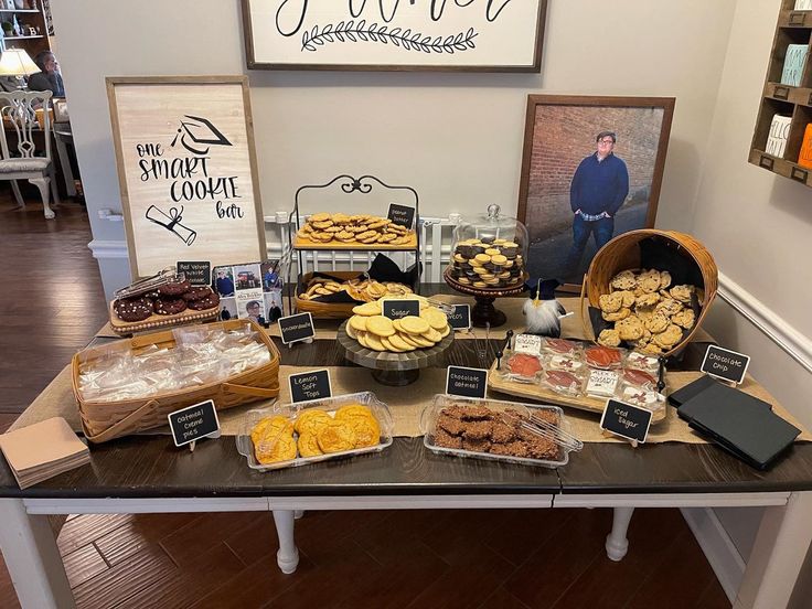 a table filled with lots of different types of pastries and desserts on top of it