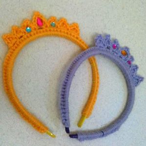 two crocheted headbands are laying on the floor