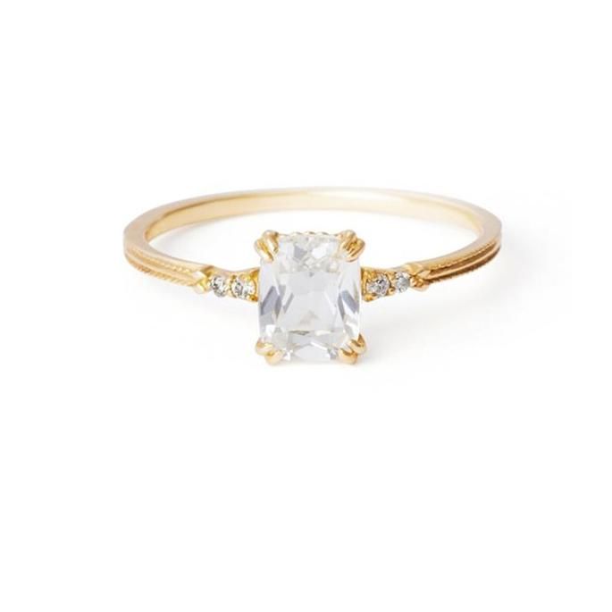 This ring is fashioned with brilliant 14K gold and enhanced with a large natural crystal center gemstone. It features a thin band that can be stacked with other stackable rings. Perfect for anyone who loves adaptable, luxurious jewelry. A combination of chic beauty, plus royal simple elegance that speaks boldly about your great style and personality. Great choice for a promise, wedding or engagement ring for that special person. Metal Electroplating: 14K Yellow Gold Main Stone: Natural Crystal M Gold Emerald Cut Engagement Ring, White Crystal Ring, Luxurious Jewelry, Emerald Cut Engagement, Silver Rings With Stones, Dainty Gold Rings, Emerald Cut Rings, Emerald Engagement Ring Cut, Engagement Style