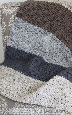 a crocheted blanket sitting on top of a couch