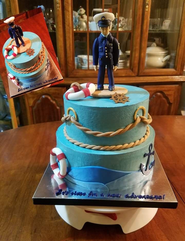 a cake decorated with an image of a sailor and life preserver on the top