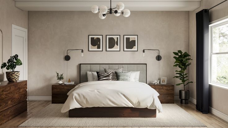 a bedroom with a bed, dressers and two pictures on the wall above it