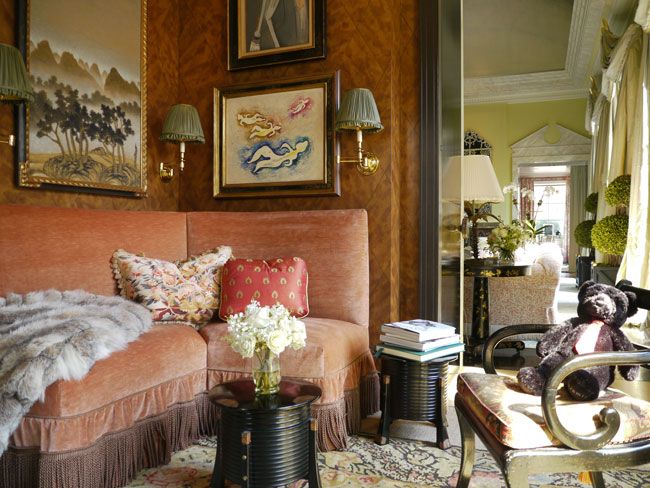 a living room filled with furniture and pictures on the wall