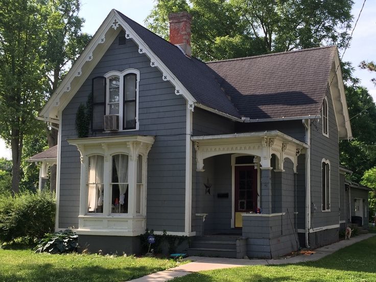 a gray house with white trim and windows