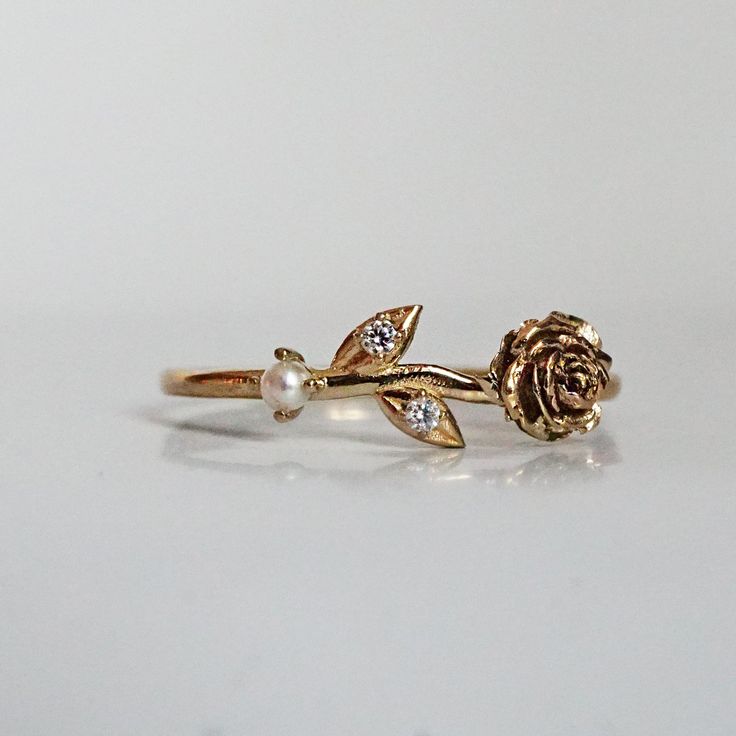 Our special collection of birth flower rings are inspired by the love of wearing something meaningful. Each birth flower is adorned with that month's birthstone. June's birth flower is Rose and the birthstone is pearl. Materials: 14K solid gold 2mm natural pearl Two natural round diamonds 1.1mm band thickness ** This item is specially made for you. Please allow 1-2 week lead time. Shipping:Domestic: Free standard shipping within the U.S.International: Free standard shipping for orders over $200 14k Gold Rose Flower Ring Gift, Rose Flower 14k Gold Anniversary Ring, Heirloom Rose Gold Flower Ring As Promise Ring, Heirloom Rose Gold Flower Ring For Promise, Heirloom Rose Gold Flower Promise Ring, 14k Rose Gold Flower Ring With Birth Flower, Delicate Rose Gold Pearl Ring Gift, Dainty 14k Rose Gold Pearl Ring, Delicate Rose Gold Pearl Ring For Anniversary