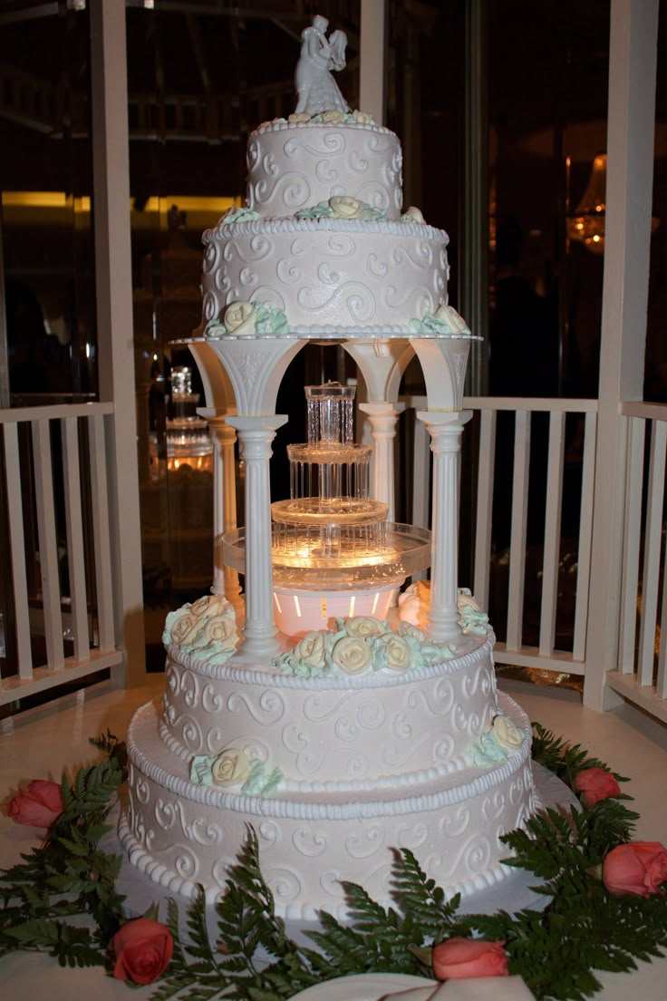 a white wedding cake sitting on top of a table