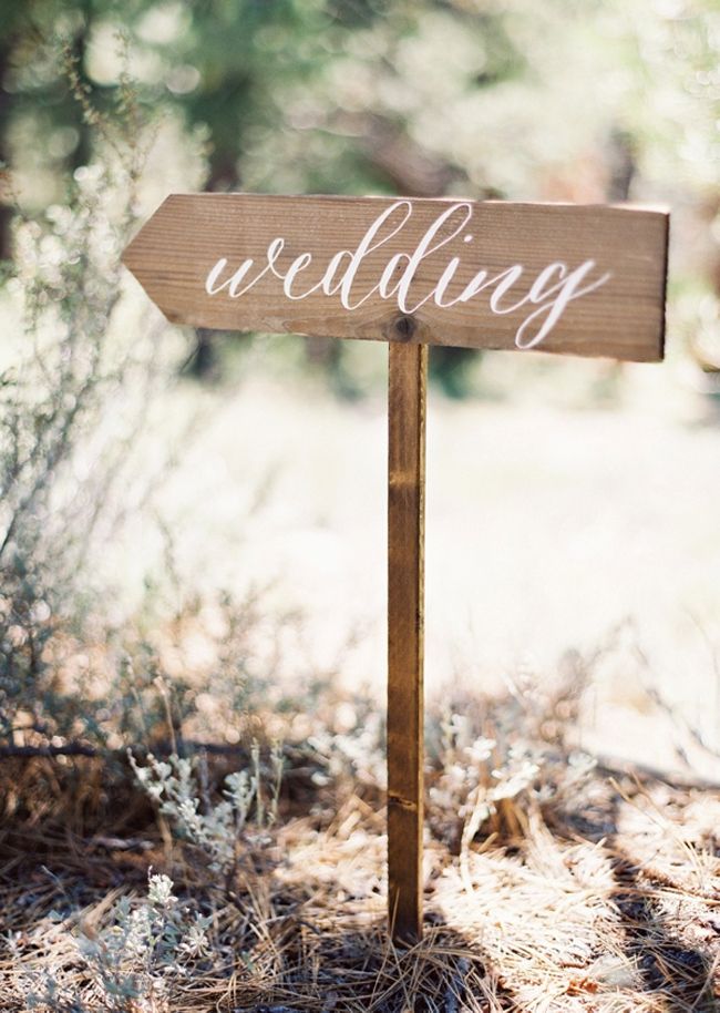 a wooden sign with the word wedding written on it