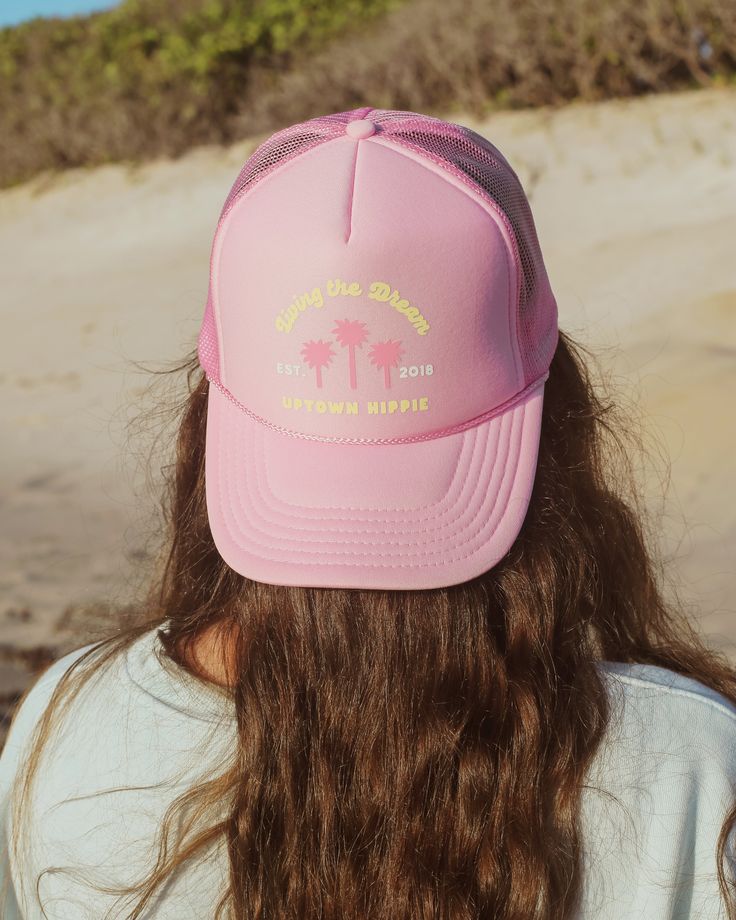 Our new Living the Dream Trucker Hat is available in three vibrant colors—light pink, seafoam, and brown—perfect for adding a pop of color to your adventures. Designed with a breathable mesh back and an adjustable strap, this hat guarantees a comfortable fit for all head sizes. Product Details Unisex One Size Fits All Adjustable Strap Made with Love Summer Sports Hat With Mesh Back, Beach Trucker Hat Breathable Cap, Pink Sun Hat With Curved Brim For Outdoor Activities, Beach Mesh Snapback Hat, Summer Lightweight Visor Trucker Hat, Adjustable Pink Hat For Outdoor Activities, Lightweight Summer Trucker Hat With Visor, Adjustable Mesh Baseball Cap For Beach, Adjustable Trucker Hat For Spring Outdoor Activities