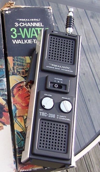 an old style walkie talkie sitting on top of a table next to a box