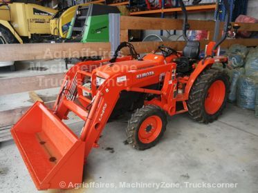 an orange tractor is parked in a garage