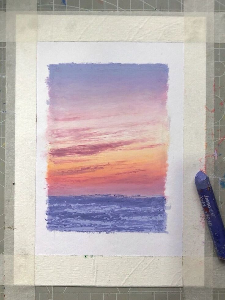 a watercolor painting of a sunset over the ocean with a blue pen on it