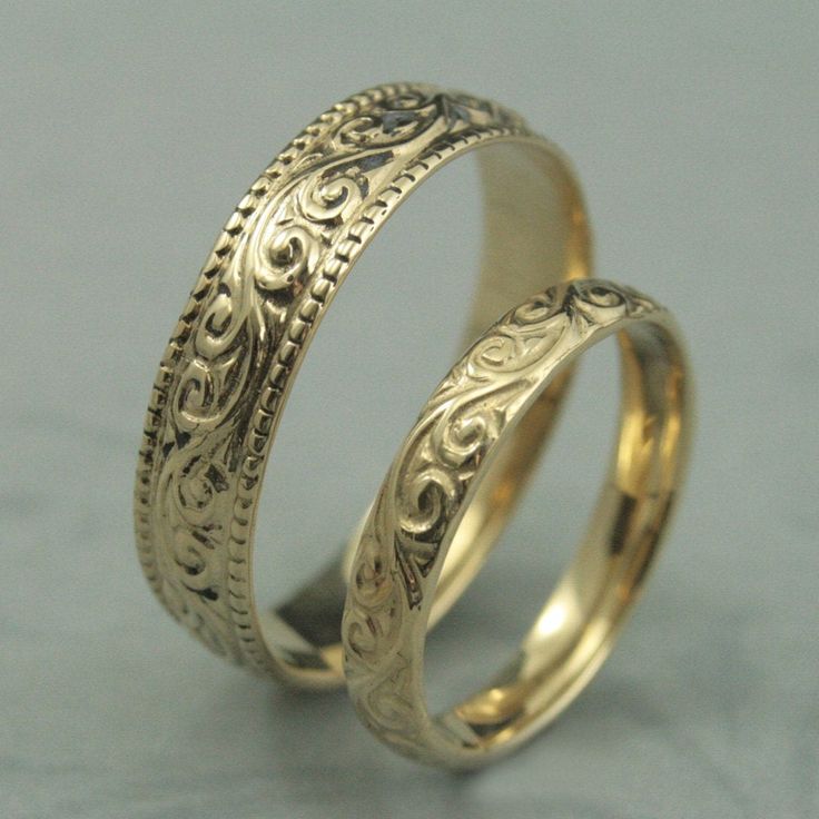 This is a wonderfully lovely set for a wonderfully lovely couple! It features a vintage style design with a modern twist to it. Cast in solid 14K gold, it features a swirling design around the entire outer surface. The wider band measures 5.5mm wide by 1.5mm thick. It features a lovely milgrain edge. The thinner band measures 3.5mm wide by 1.5mm thick and features the matching design without the edge. These are quality solid gold rings to last you a lifetime and then some! Your rings can be cast Yellow Gold Wedding Rings With Intricate Design, Wedding Engraved Ring With Intricate Design In 14k Gold, 14k Gold Engraved Wedding Ring With Intricate Design, 14k Gold Engraved Ring With Intricate Design For Wedding, Gold Filigree Engraved Wedding Ring, Heirloom Gold Engraved Wedding Ring, Gold Wedding Jewelry With Classic Design, Elegant 14k Gold Wedding Couple Rings, Engraved 14k Gold Wedding Jewelry