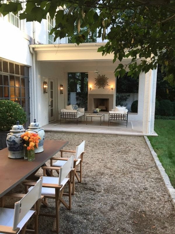 an outdoor dining area with table and chairs