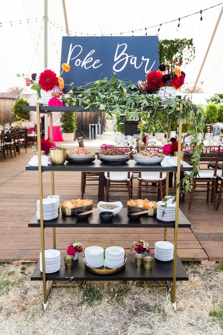 a table set up with plates and bowls on it for an outdoor party or function