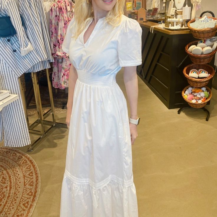 Our Cotton Maxi Dress Includes A Split Neckline Framed By Short Sleeves Tops A Flowy Midi Skirt That's Separated By A Smocked Waistline. Pleated Layer Details Sweep Across The Bottom Third Of The Skirt To Create A Single Tier. Wear It To Go To Dinner Or For A Lovely Afternoon Event. - Breathable - Split Neckline - Smocked Waist - Pockets - Comes In 4 Colors Size + Fit - Model Is 5'8" And Wearing Size Xs - Measurements Taken From Size S - Chest: 19 3/4" - Length: 55" Classic Summer Dress With Smocked Back, Classic Maxi Dress For Spring Daywear, Classic Midi Dress For Spring Brunch, Classic Spring Dress For Vacation, Classic Spring Vacation Dress, Classic Spring Dress With Smocked Back, Flowy Midi Skirt, Cotton Maxi Dress, White Cotton Dress