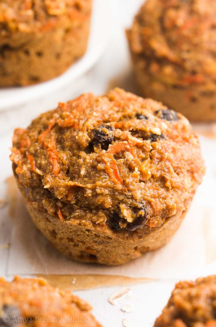 carrot and raisin muffins sitting on top of paper