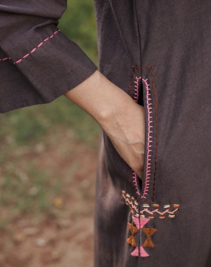 a woman's hand is holding the back of her dress