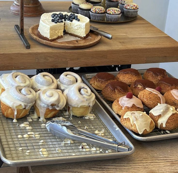 various pastries and desserts sitting on trays