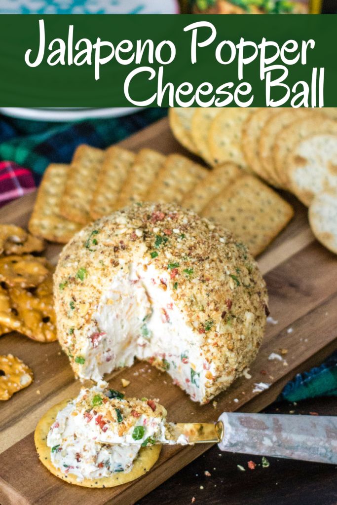 a cheese ball is on a cutting board with crackers